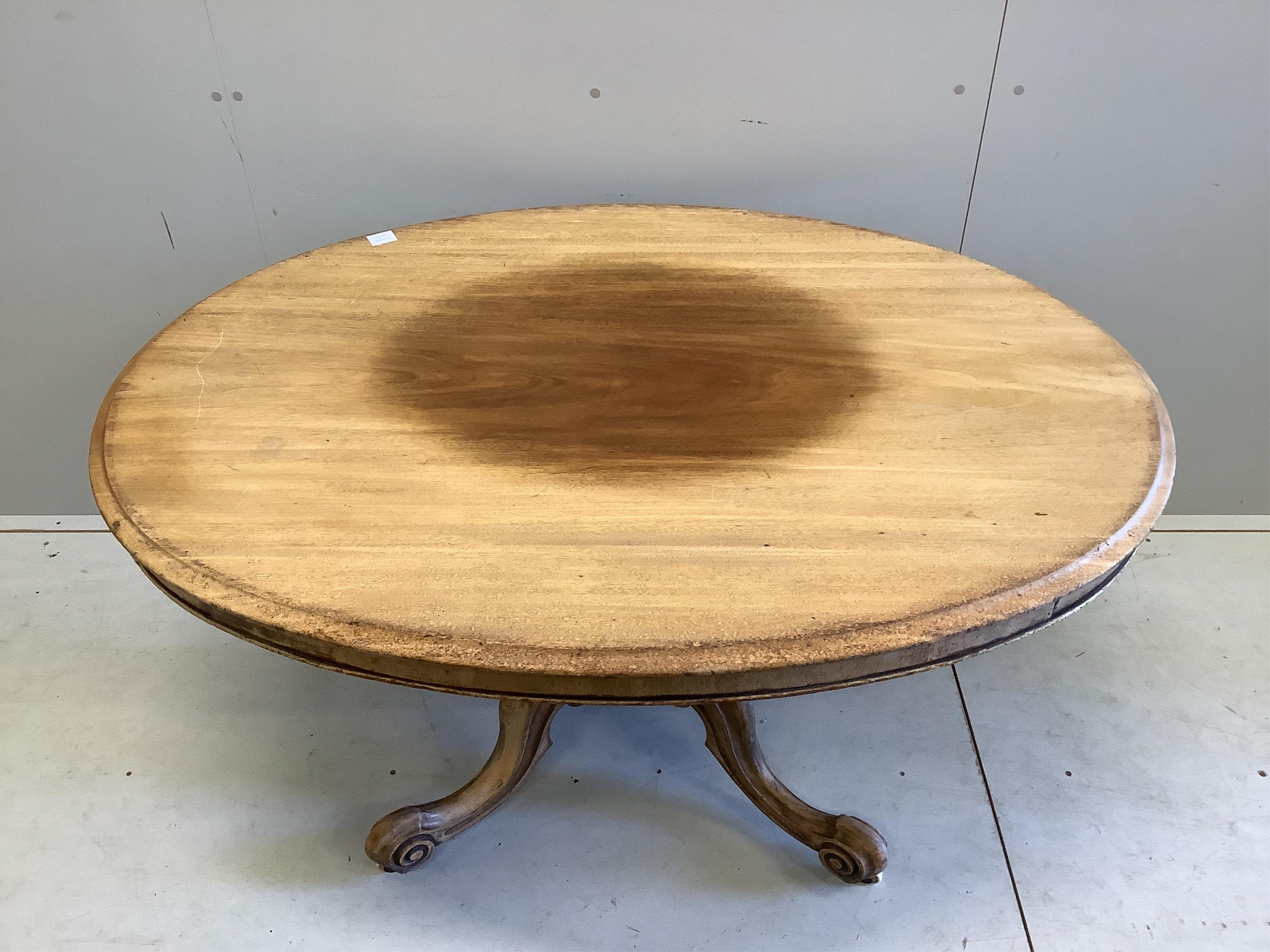 A Victorian faded mahogany oval tilt top loo table, width 137cm, depth 103cm, height 73cm